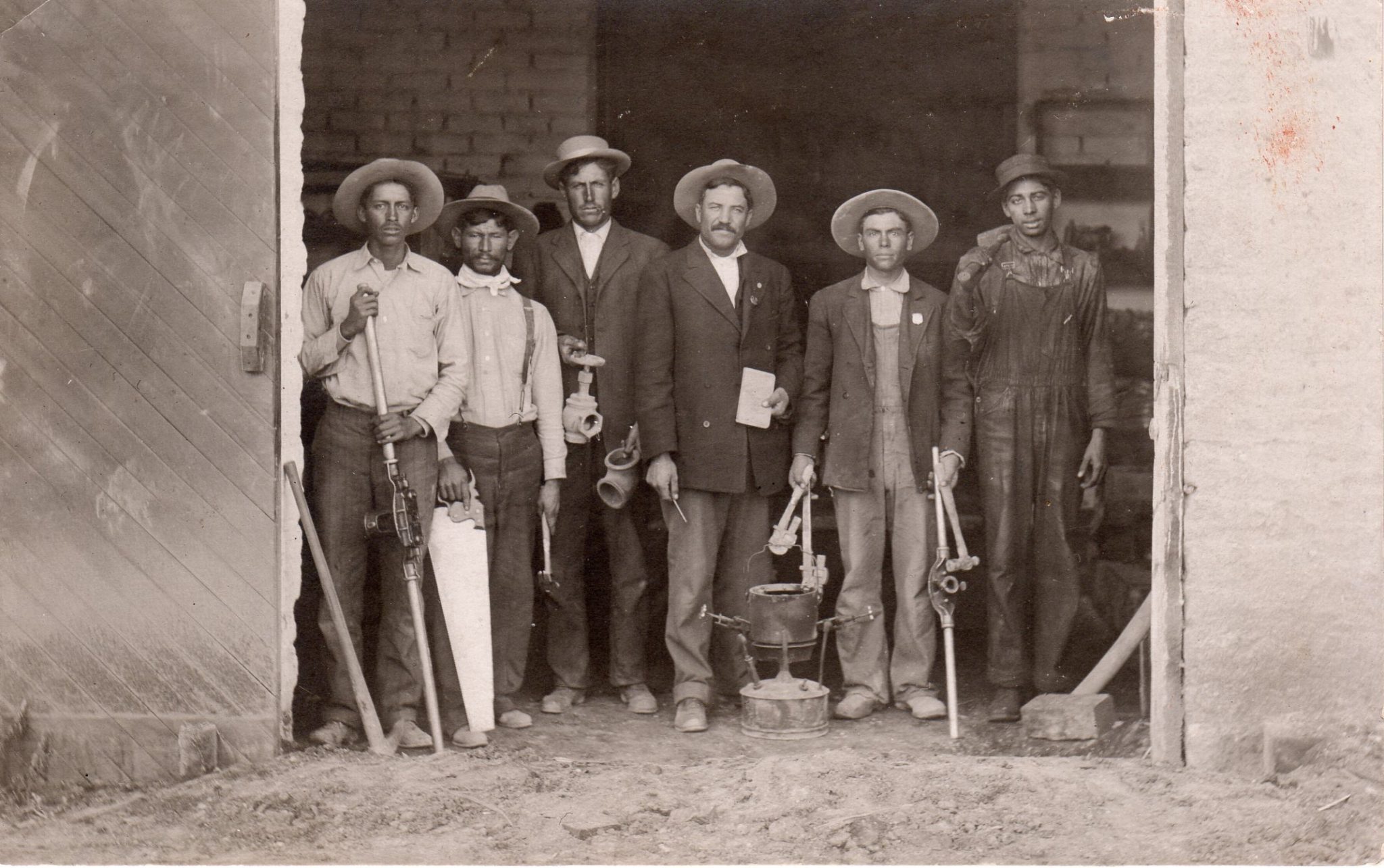 Johnny Warner Plumbing. Tucson A. T. Johnny pictured in center right with hammer.