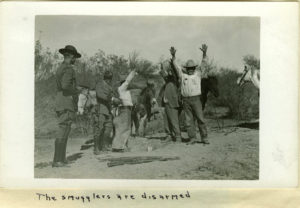 Booze smugglers with their hands in the air