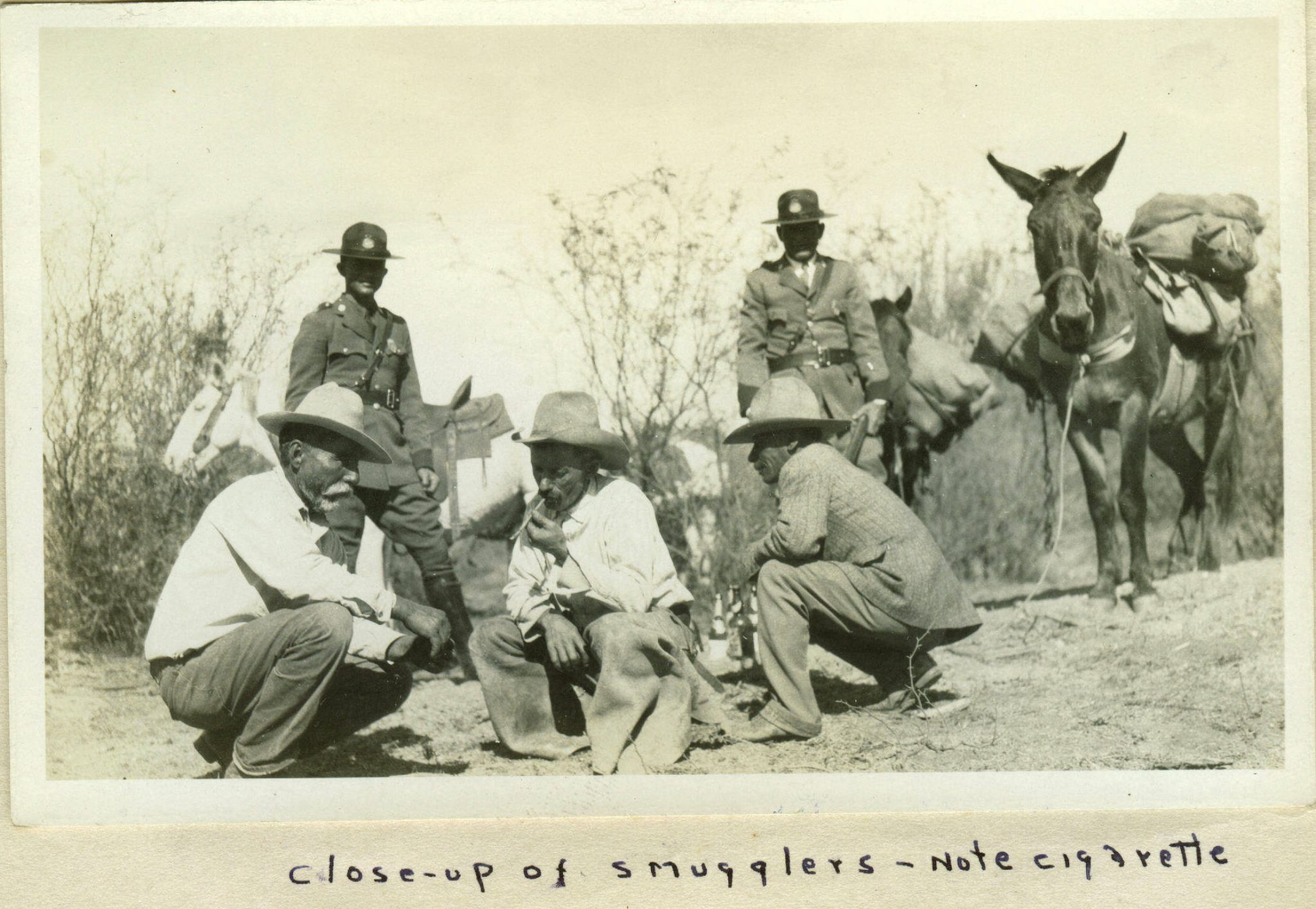 Close -up of smugglers - note cigarette